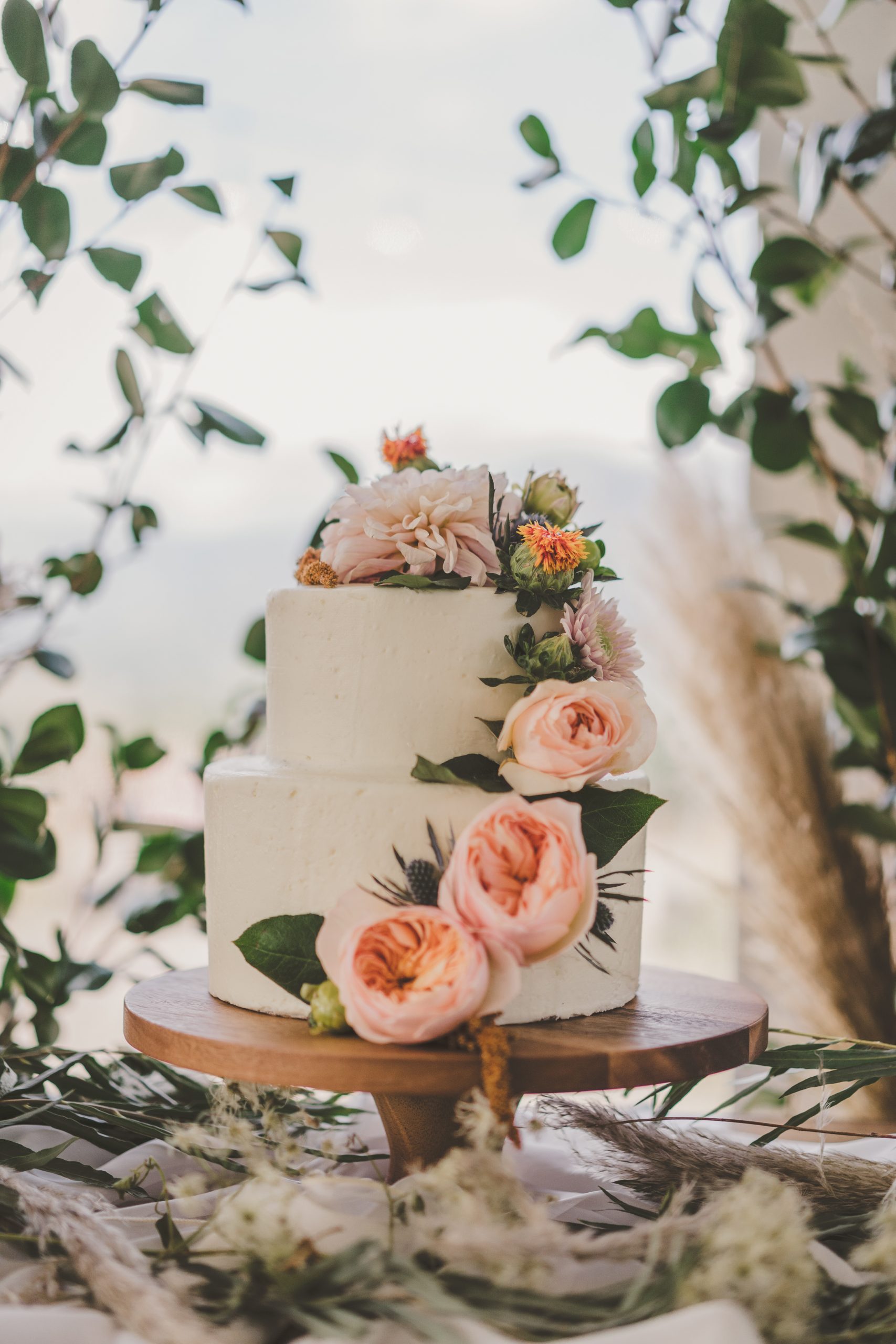 white buttercream cake with peach flowers