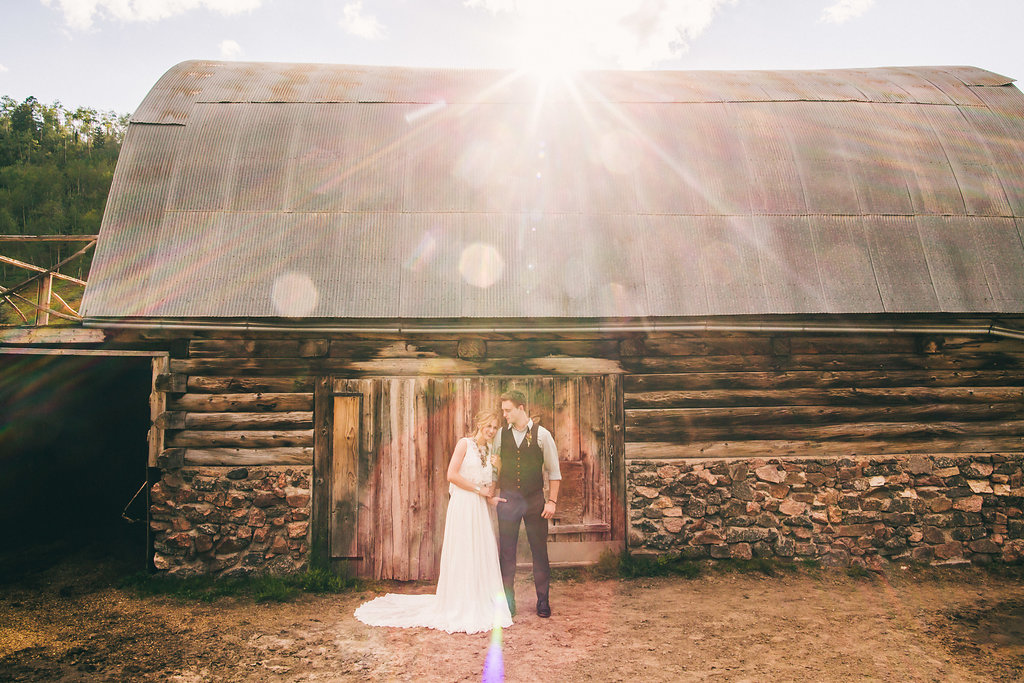 newlyweds by wood barn