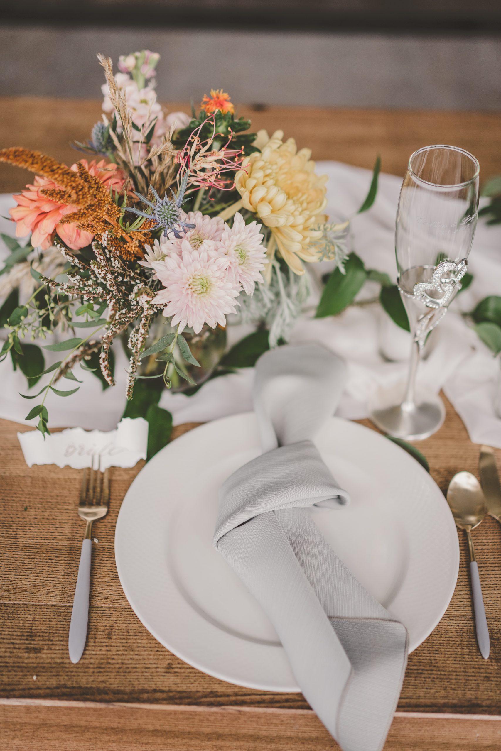 Place setting with gray napkin and gray and gold silverware