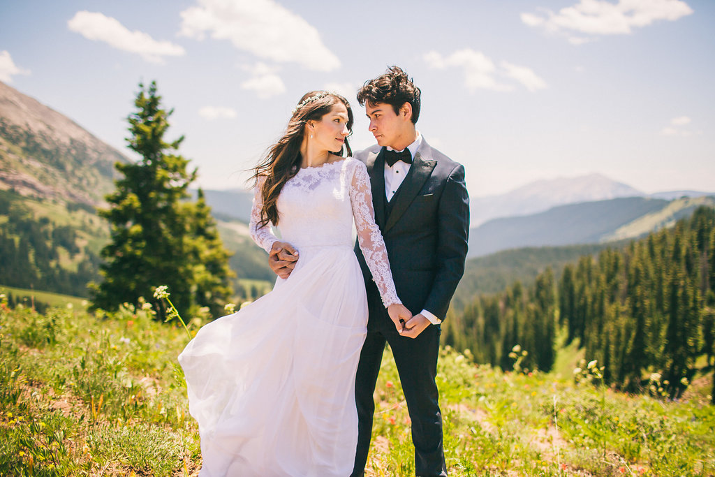 elopement on a mountain. Wind blowing a wedding dress
