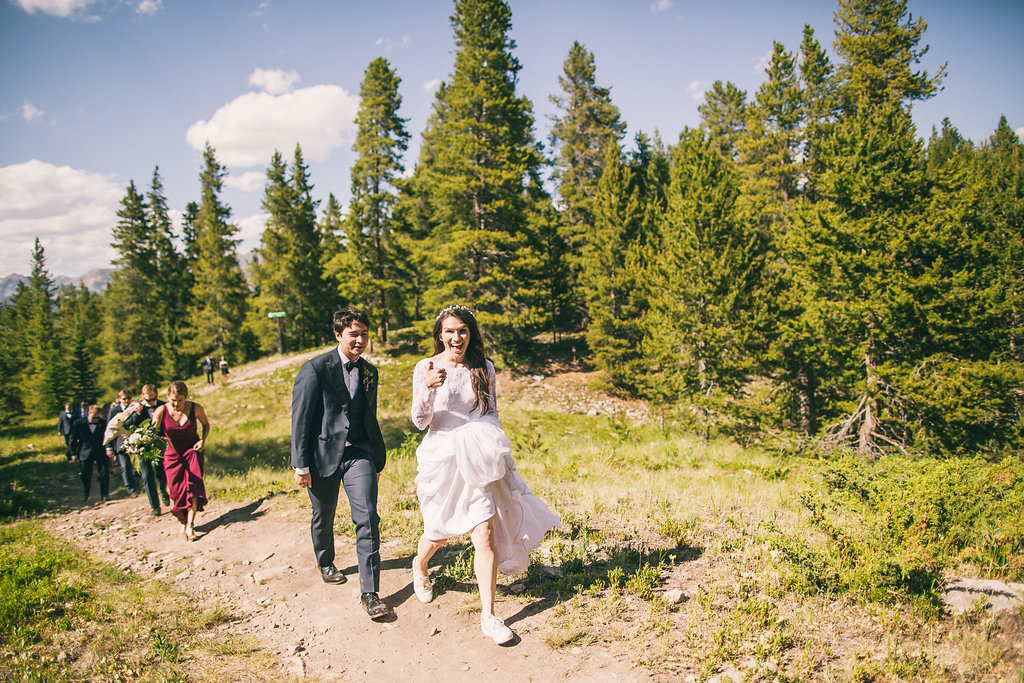 wedding adventure. Wedding party walks to the reception in the mountains
