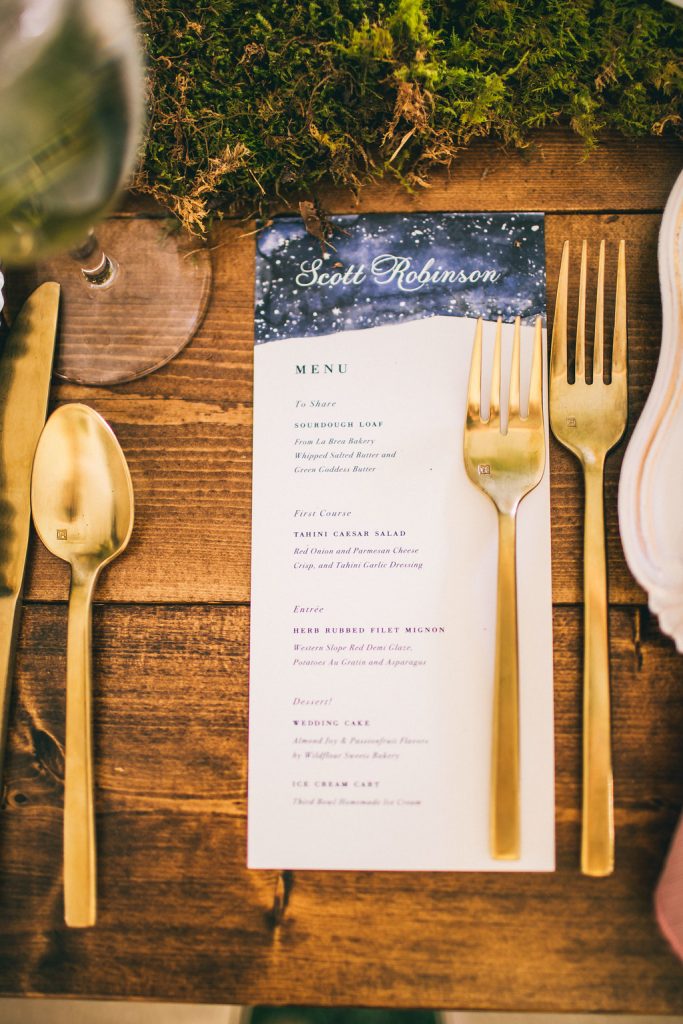 hand illustrated wedding menu with a nigh sky painted on top
