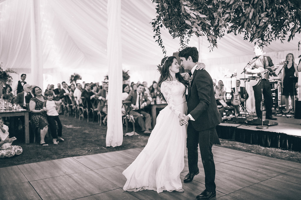 bride and groom first dance in tent