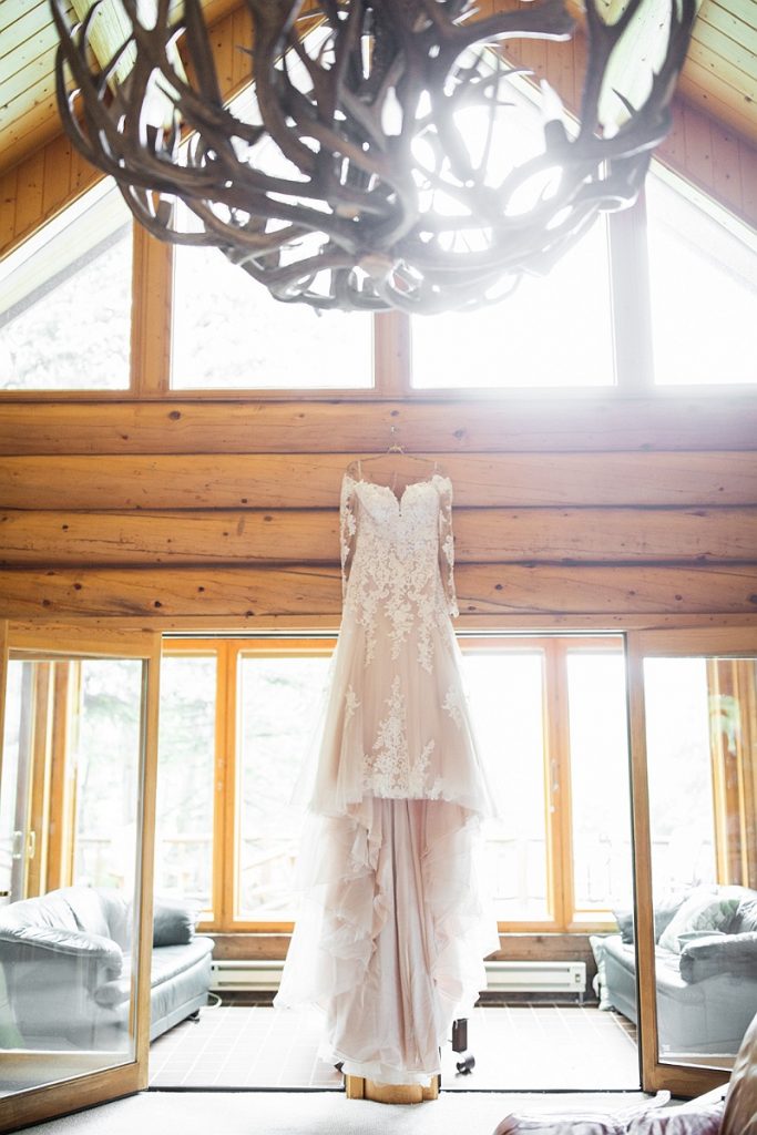 Mountain Wedding Garden Bridal Gown Hanging in Cabin