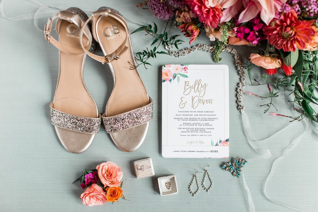 Devon + Billy Mountain Wedding Garden details photo with shoes, rings, invitation, bouquet, boutonniere