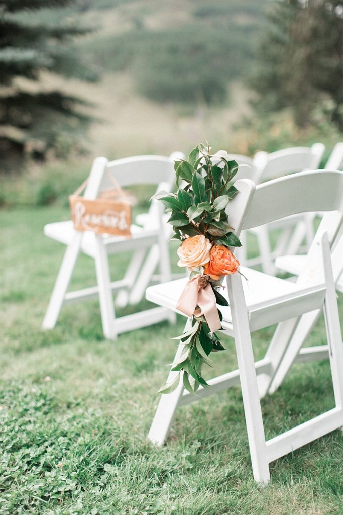 Devon + Billy Mountain Wedding Garden ceremony chairs with florals