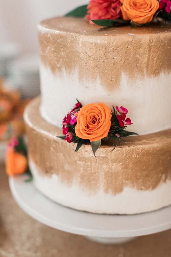 Devon + Billy Mountain Wedding Garden wedding cake with gold detailing and florals